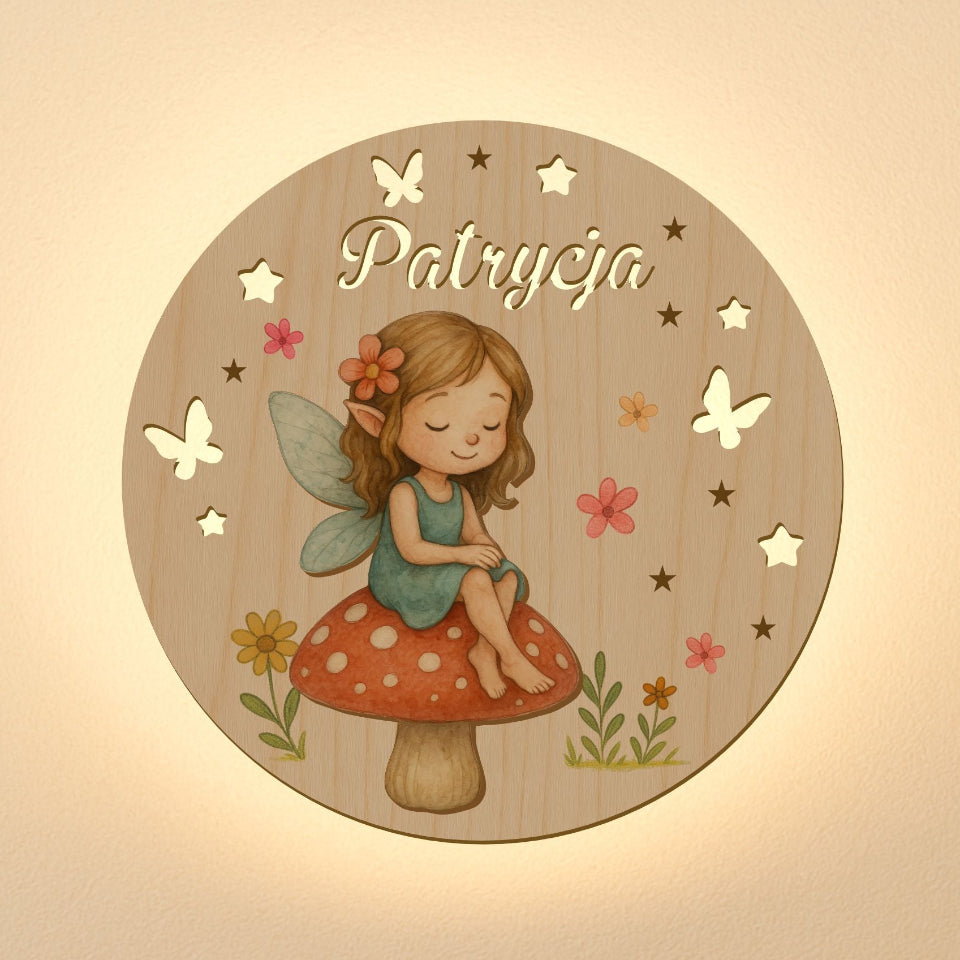 Wooden plaque with a fairy sitting on a mushroom, surrounded by flowers and butterflies, with 'Patrycja' engraved.