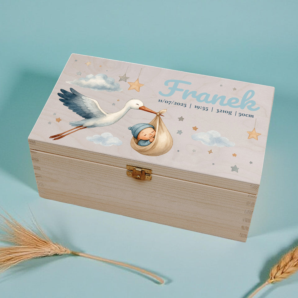 Wooden box with stork and baby design on a light blue background