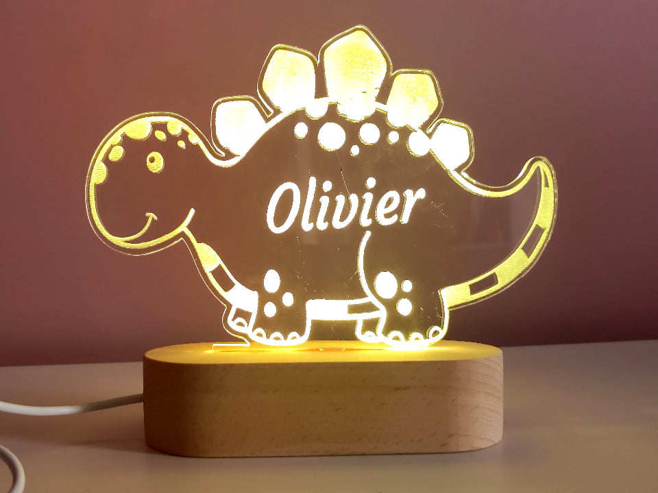 Multicolored dinosaur-shaped LED night lamp, powered by USB or batteries, featuring a controller for light settings.