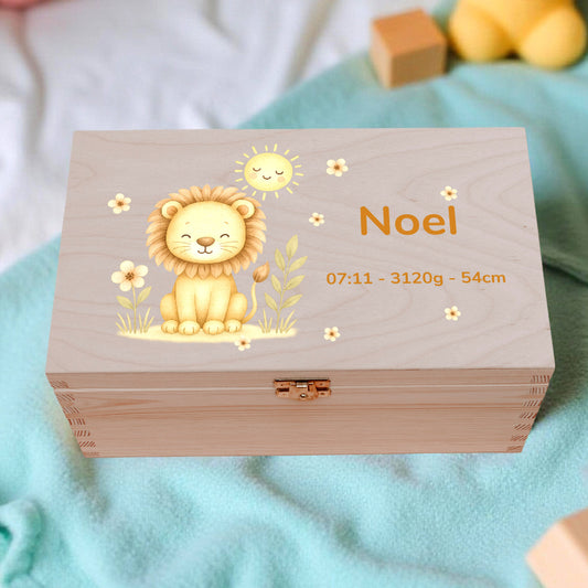 Wooden box with a lion design and text, surrounded by toys on a soft surface