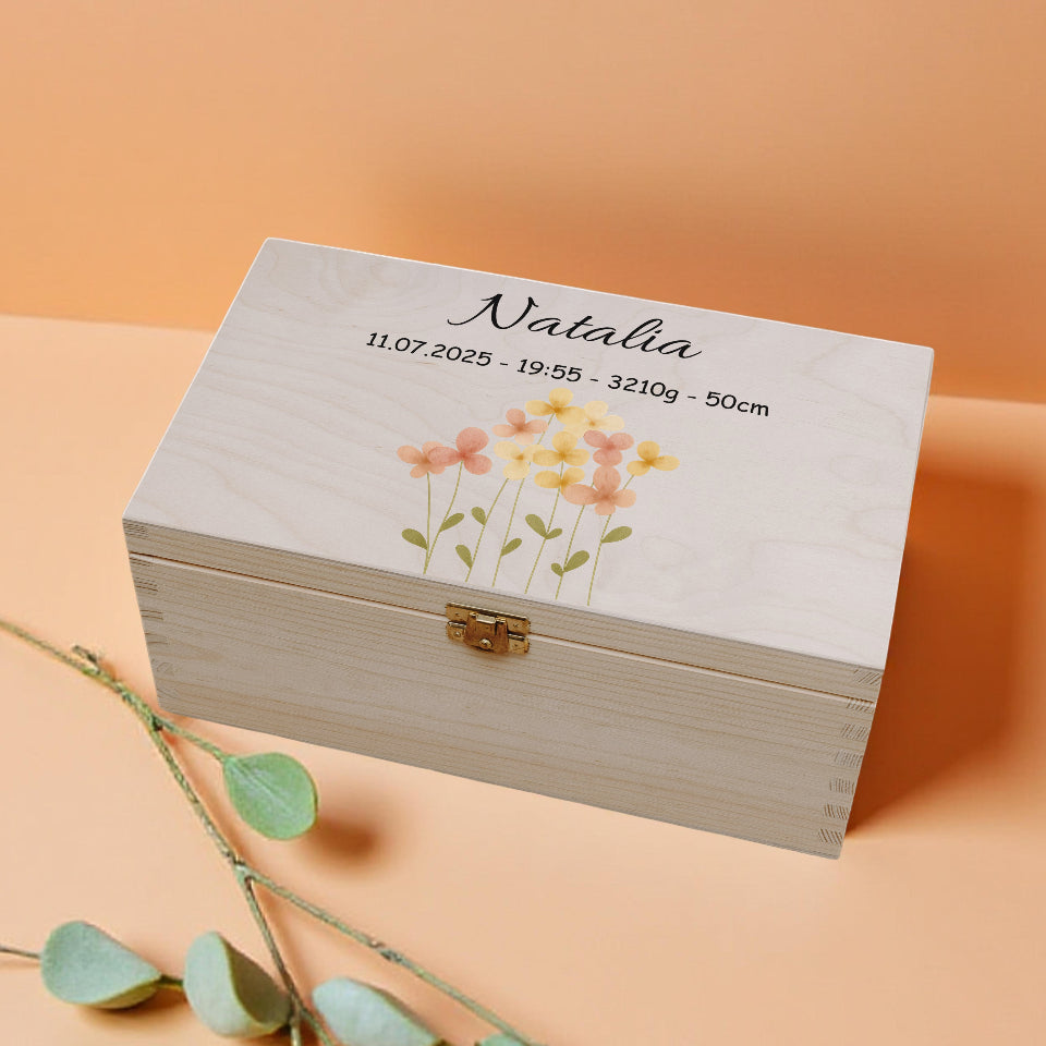 Wooden box with floral design and text on a peach background