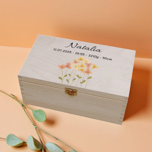 Wooden box with floral design and text on a peach background