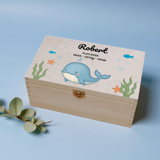 Wooden box with whale design and text on a blue background