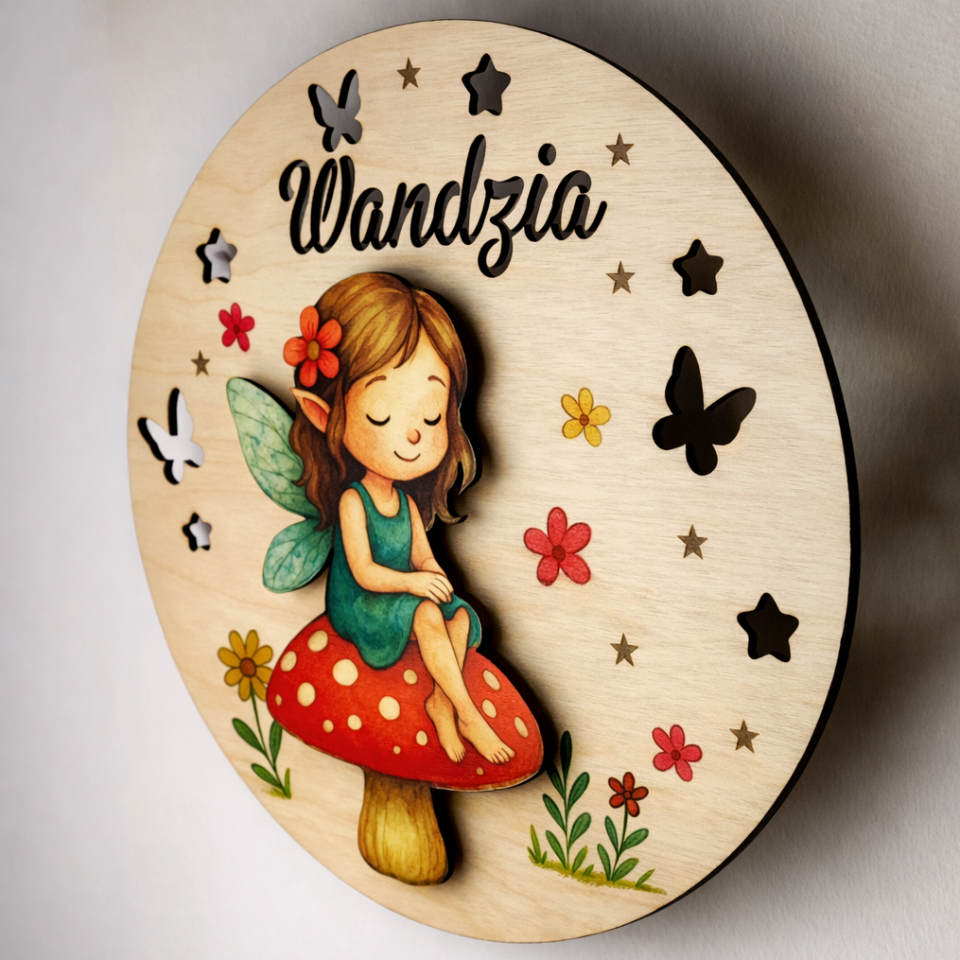 Wooden plaque with a fairy design and 'Wandzia' branding on a light background