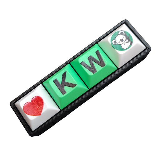 A custom mechanical keyboard switch plate or decorative plate featuring four square keys: a red heart, green 'K', green 'W', and a white koala icon on a green circle, all set in a black frame against a white background.