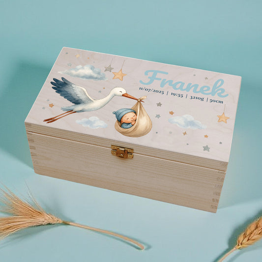 Wooden box with stork and baby design on a light blue background