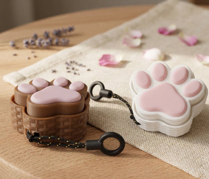 Cat paw-shaped case on a wooden surface with decorative elements.