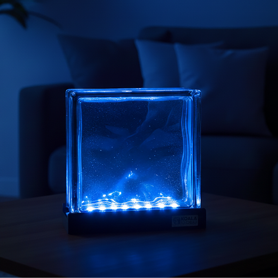 Blue illuminated glass block on a dark background