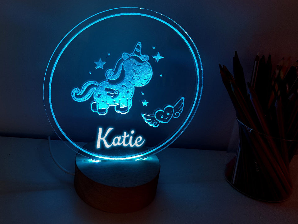 A unicorn night lamp name with multicolored LED lights, USB or battery-powered, and a controller for adjustments.
