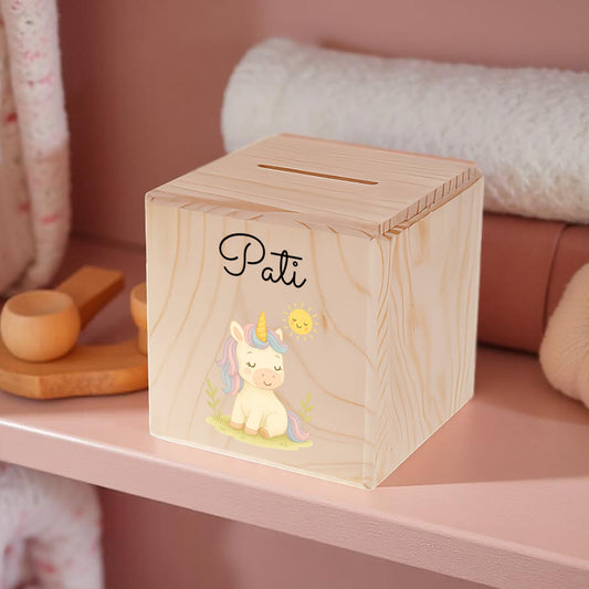 Wooden money box with a unicorn illustration and 'Pati' branding on a pink shelf.